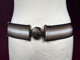 brown and white striped belt on mannequin torso with metal buckle