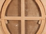 a wooden clock with a circular design on it