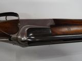 a close up of a rifle on a white surface