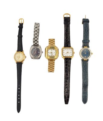 a group of four watches sitting next to each other on a white surface
