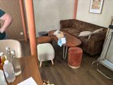 a woman standing in a living room next to a couch