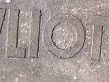 a black and white photo of the word love written on the sidewalk