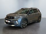 a grey toyota rav parked in a room with a white wall