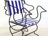 a blue and white striped chair sitting on a white floor
