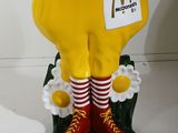 statue of a mcdonald ' s chicken with a red hat and red striped socks