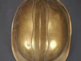 brass plate with a curved design on the top of it