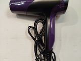 purple and black hair dryer sitting on top of a white table