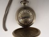a silver pocket watch with roman numerals on it