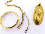 a gold necklace with a picture of a person on it