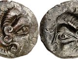 a silver coin with an image of a dragon on it