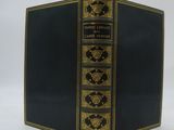 an old black book with gold trim and gold trim on the cover