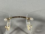 the glasses are clear and have gold rims on them