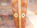 a large wooden cabinet with two doors and two knobs