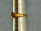 a thermometer on a pole with a gold band