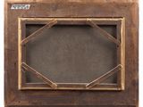 an old wooden frame with a picture hanging on the wall
