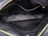 the inside of a black purse with a yellow zipper on it