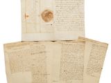 a pile of old papers with writing on them on a white surface