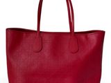 a red leather tote bag on a white background