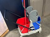 a mop and bucket on the floor next to a door