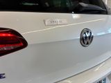 a close up of a white car with a sticker on the back of it