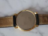 an image of a close up of a watch on a marble surface