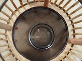 a close up of a basket with a glass inside of it