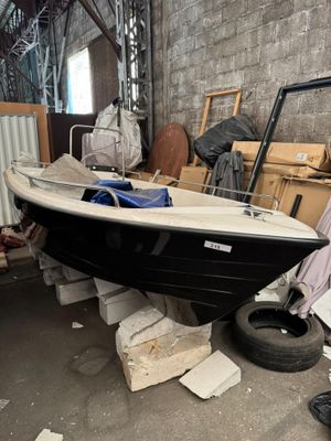 a black and white boat sitting in a warehouse