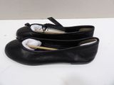 pair of black leather ballet shoes on a white surface