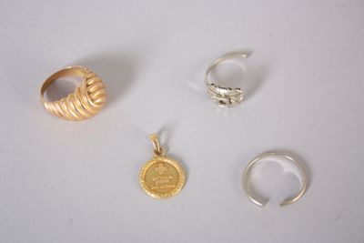 trois bagues en or et une bague en argent sur un fond blanc
