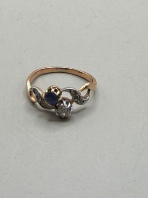 a close up of a gold ring with a blue stone on it