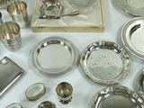 a lot of silver plates and silverware on a table