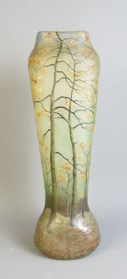 a vase with a painting of trees on it