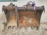 a close up of a couple of buckets sitting on the ground