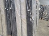 de nombreux matelas emballés dans des sacs en plastique dans un entrepôt