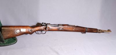 an old wooden rifle with a green hat on a white background