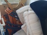 a pile of blankets and a rocking horse in the corner of a room