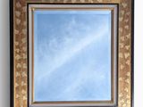 a picture of a mirror hanging on the wall