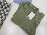 three men ' s clothing on a table with a price tag