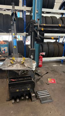a car being worked on by a mechanic in a garage