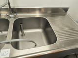 a stainless steel sink with a faucet in it