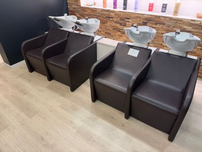 three chairs that are sitting in front of a wall