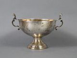 an antique silver plated bowl with handles and handles on a gray background