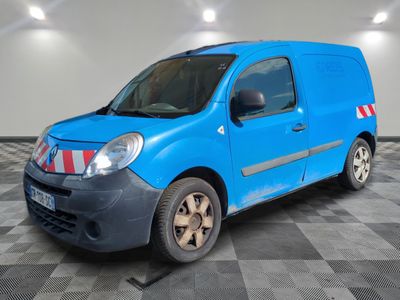 the small blue van is parked in a large room