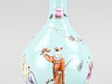 an image of a blue vase with a picture of a man and birds on it