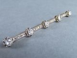 a close up of a diamond bar broocher on a table