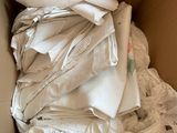 a cardboard box filled with a lot of white clothes