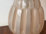 a glass lamp that is sitting on a wooden table