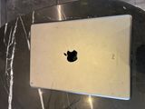 an apple laptop sitting on top of a table
