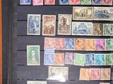 an old picture of a collection of stamps on display in a wooden frame