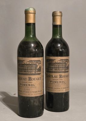 two bottles of wine sitting next to each other on top of a table